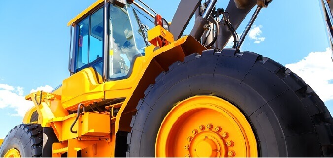 A bulldozer with a rubber windshield gasket on the cab window