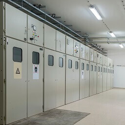 A row of white industrial generators with weatherstripping window seals