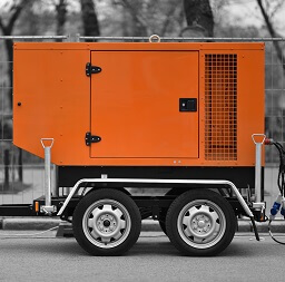 An orange portable generator on a trailer with a generator seal on the door panel