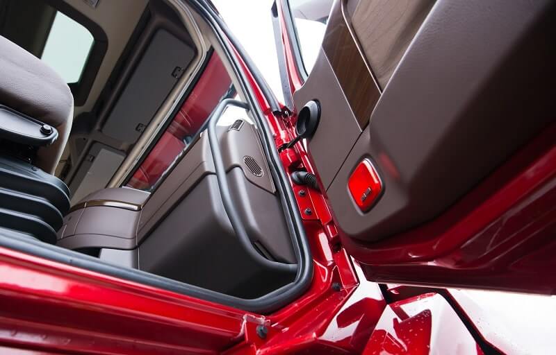 A red truck uses a door edge guard to protect against scrapes, nicks, and injuries.