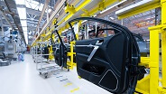 Industrial automaker’s factory floor with assembly line and car doors